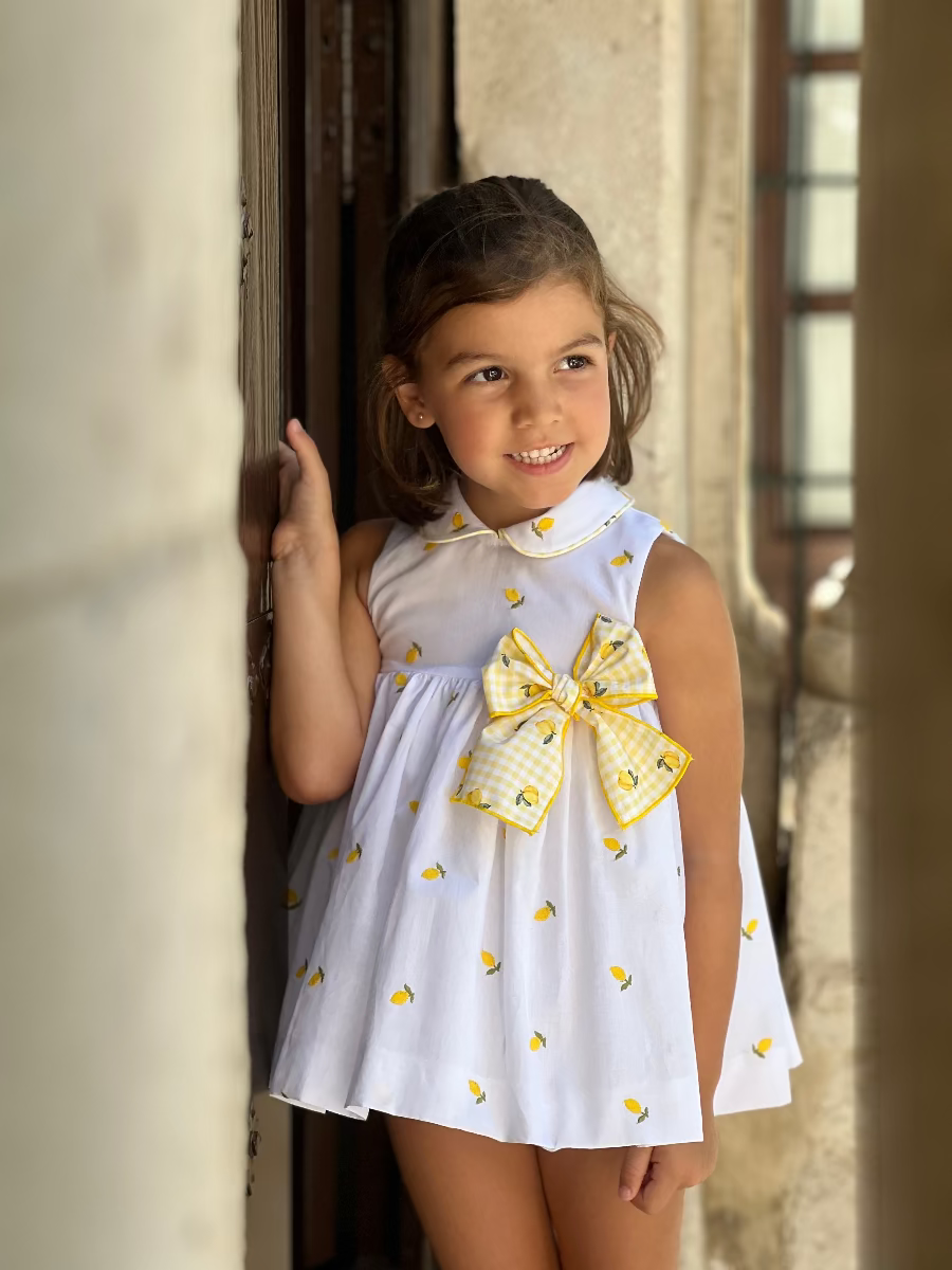 Young girl wearing La Peppa White & Lemon Print Dress