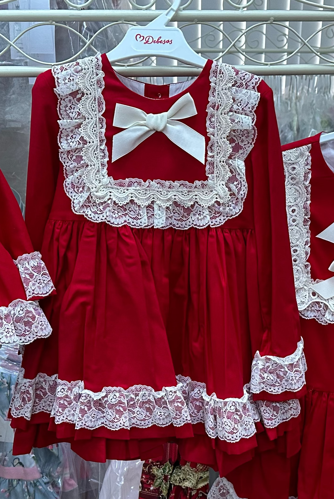 Girls red and cream dress by Debesos. Perfect for Christmas.