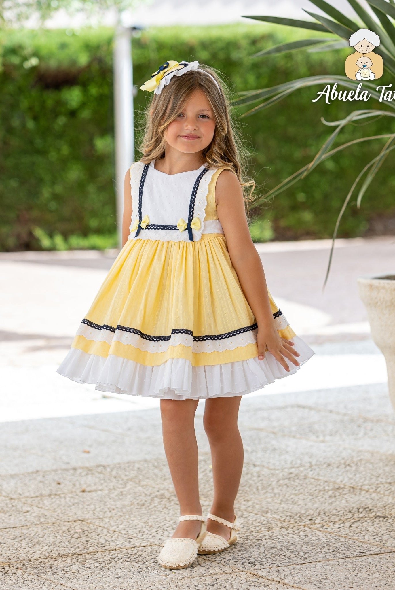 Abuela Tata girls yellow navy dress with matching headpiece SS26