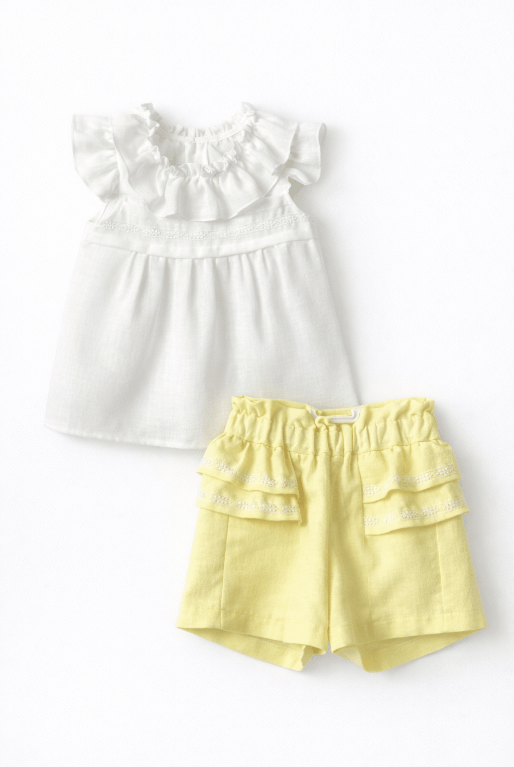 Basmarti lemon yellow girls shorts with lace ruffle detail and ivory blouse, Spanish summer outfit for girls from the SS26 collection.