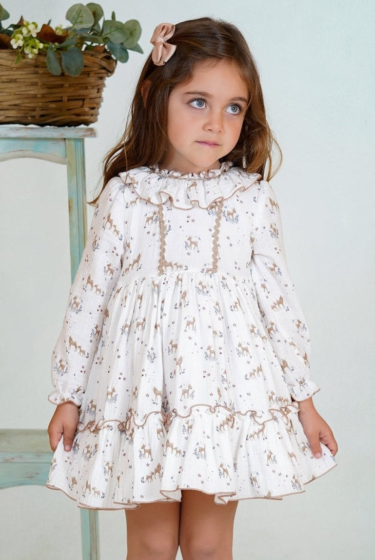 Girl wearing a long-sleeved deer print dress with ruffled collar and hem from DBB Collection AW25.