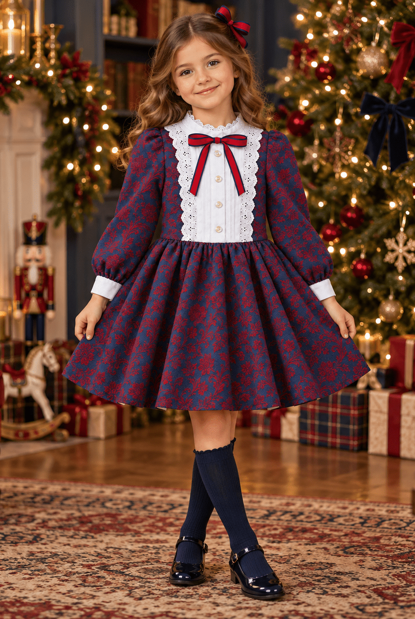 A young girl wearing Meraki Bambini Navy & Red damask dress in a christmas living room setting