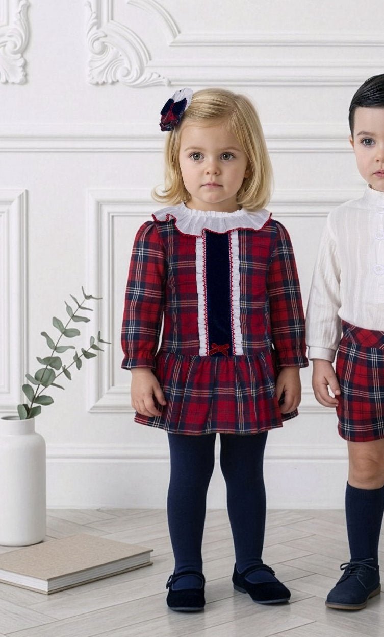 Miranda AW26 young child wearing the baby girls tartan print in red and navy dress with matching knickers.