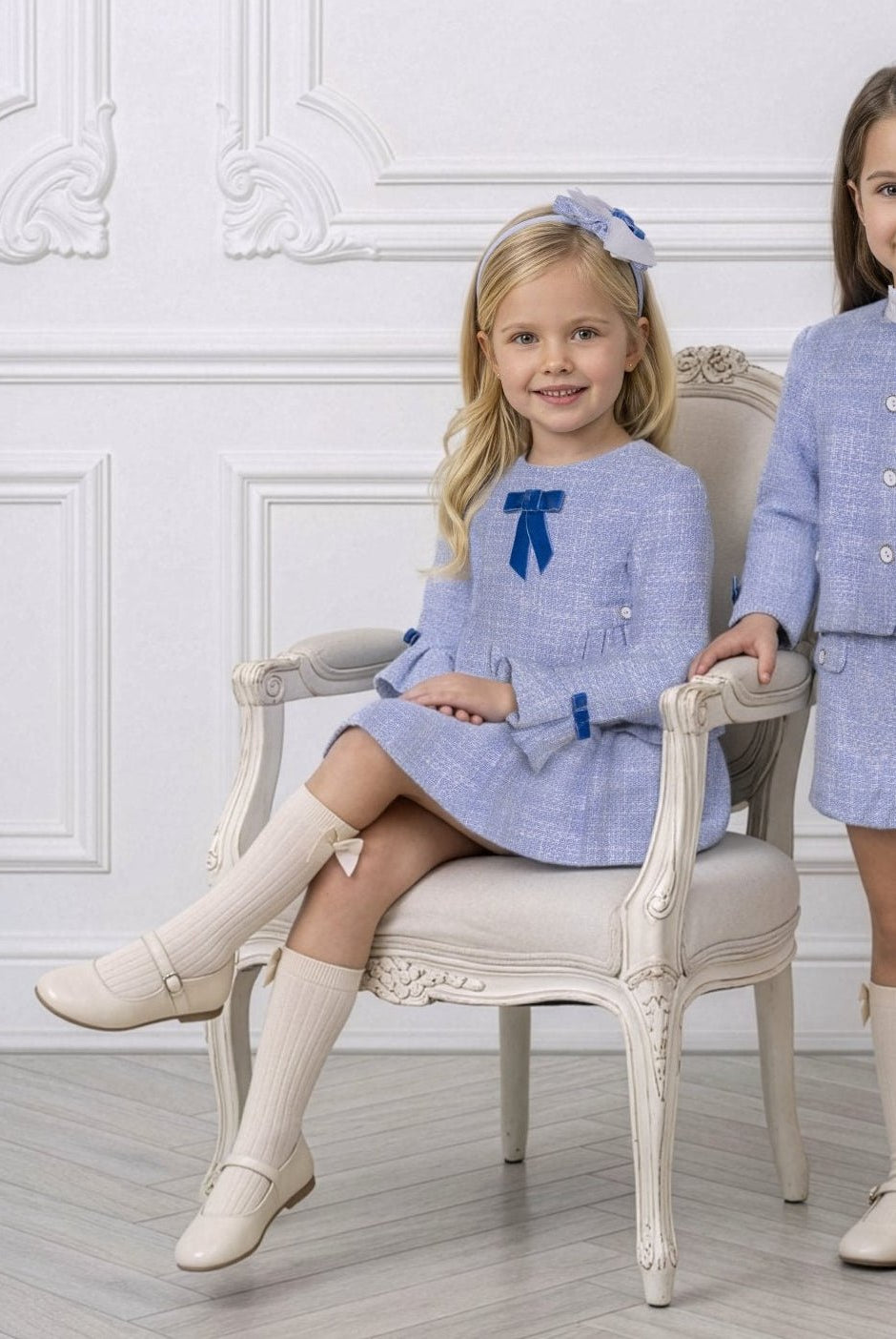 young girl wearing Miranda AW26 blue tweed dress