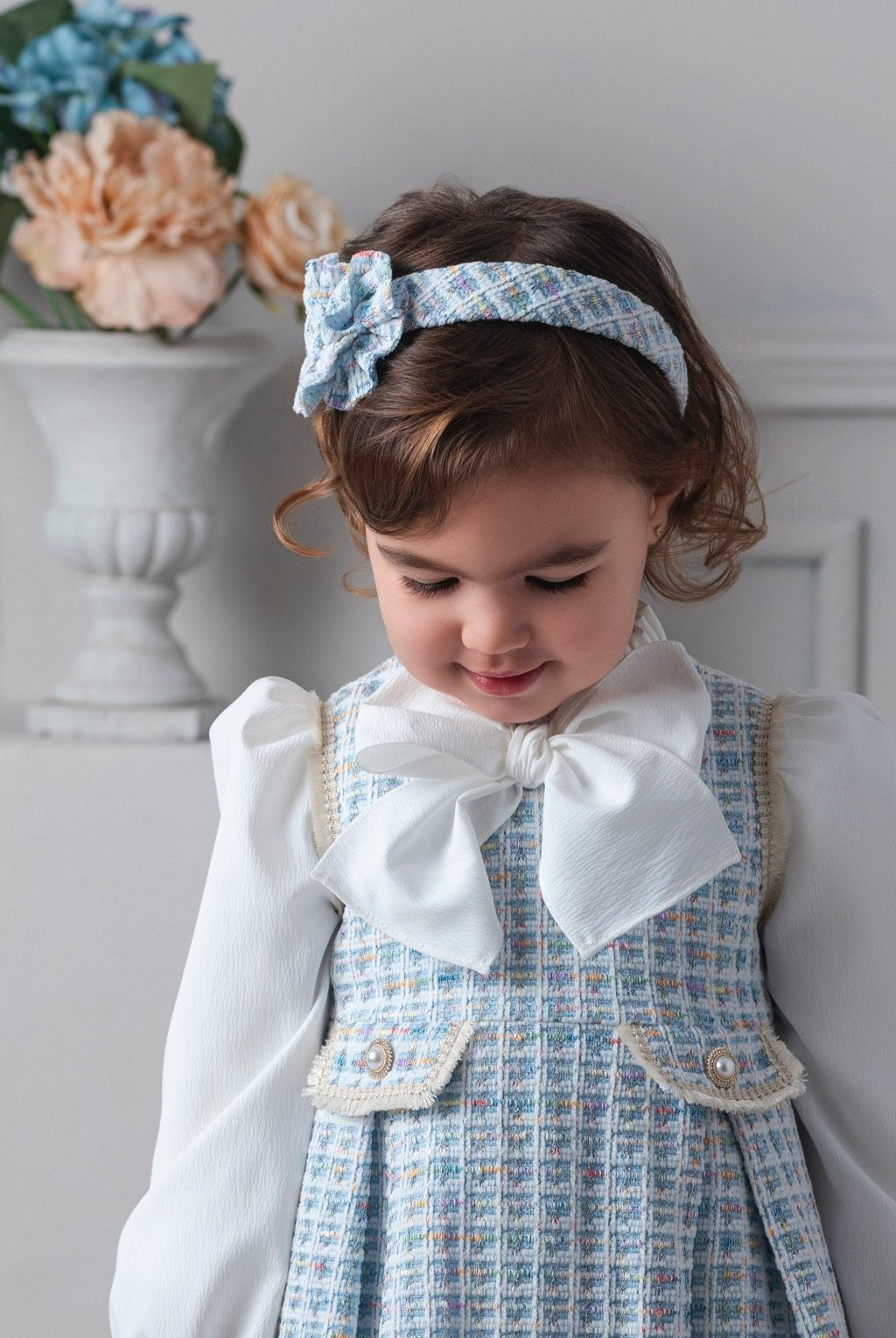 Child wearing Rochy AW25 Chanel Blue Tweed Headpiece to match the Chanel Blue Tweed Dress
