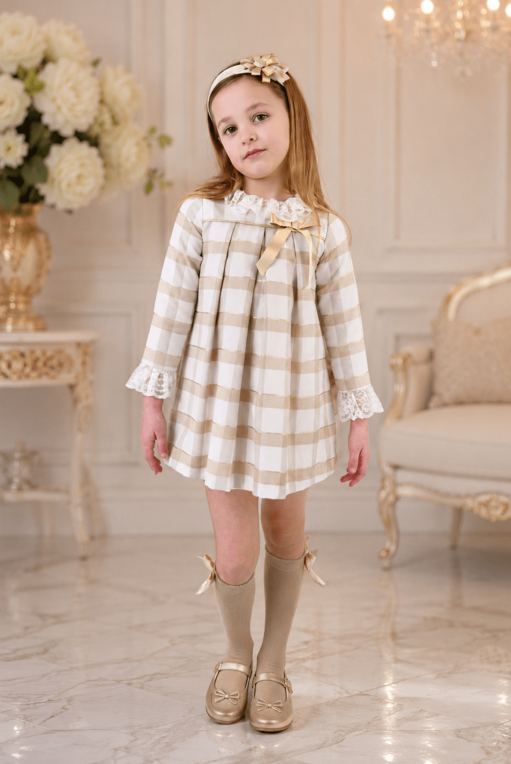 Girls Rochy Cream, Gold and Camel Dress on a child model standing in a luxury room.