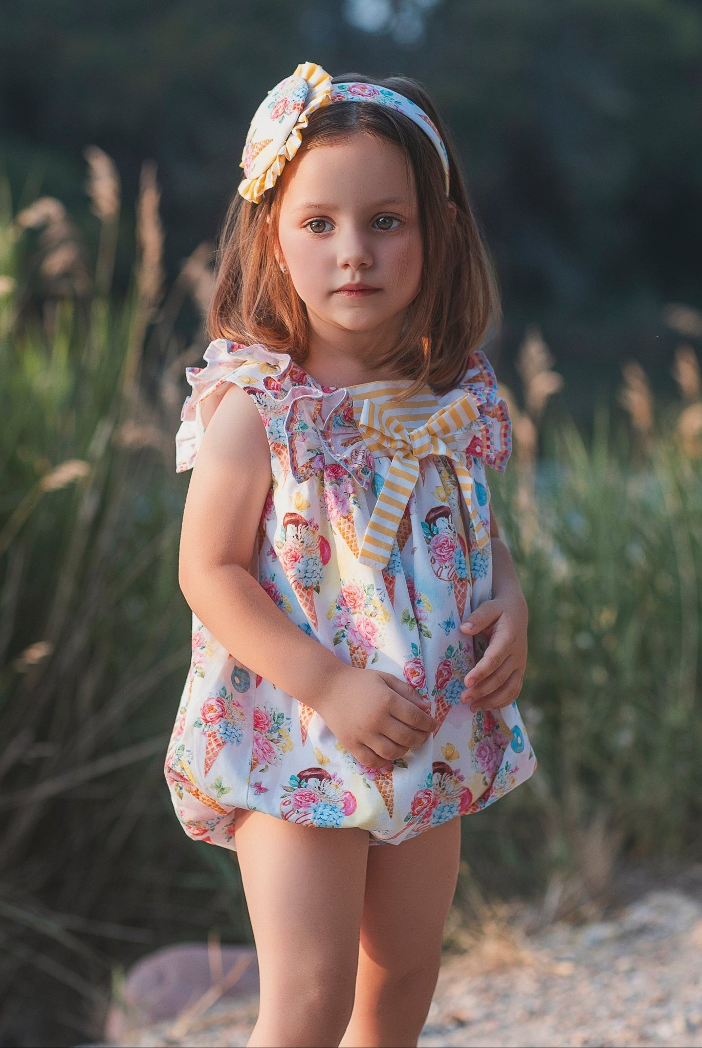 Young girl wearing rochy SS26 sweet collection Romper suit for Summer.