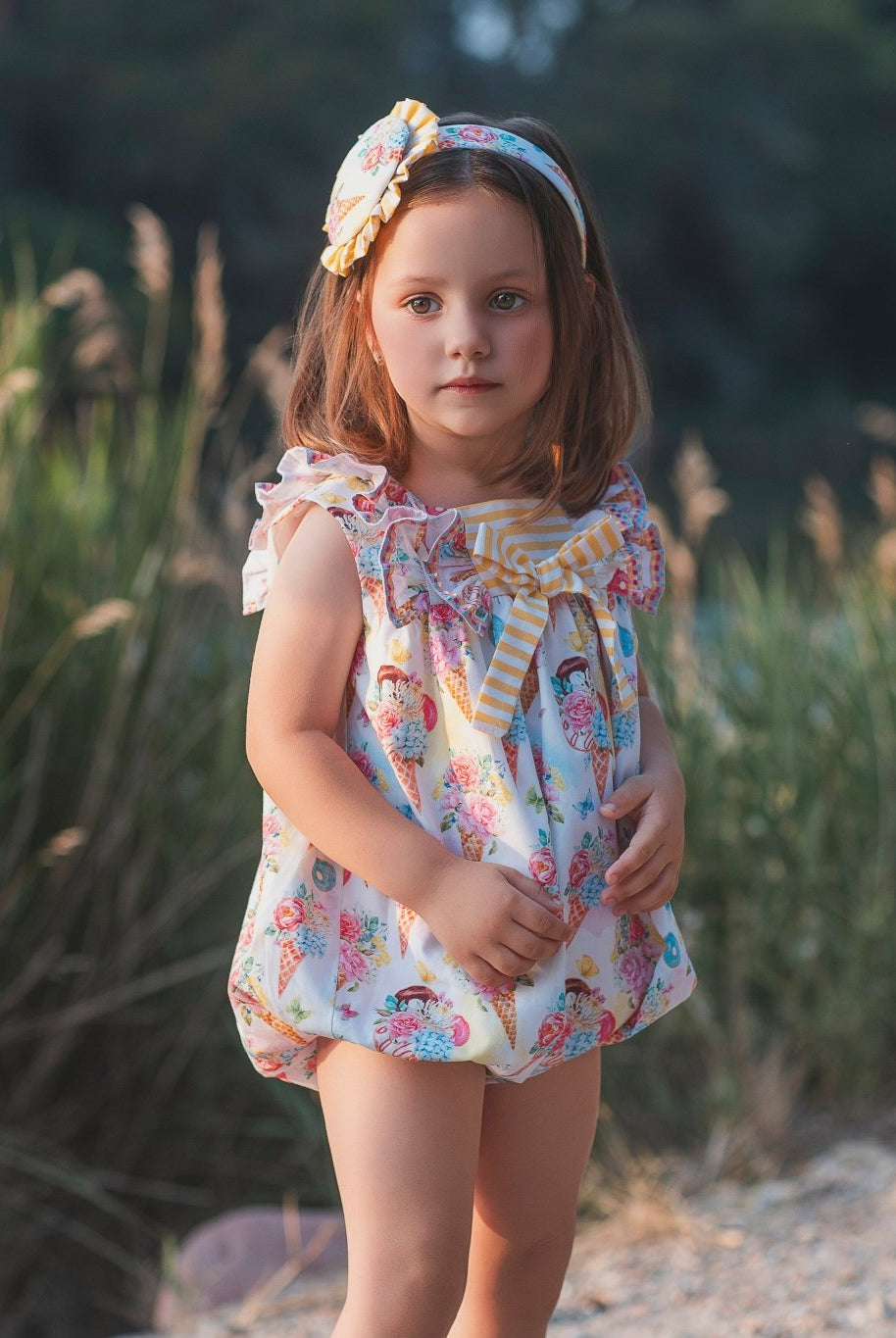 Young girl wearing rochy SS26 sweet collection Romper suit for Summer.