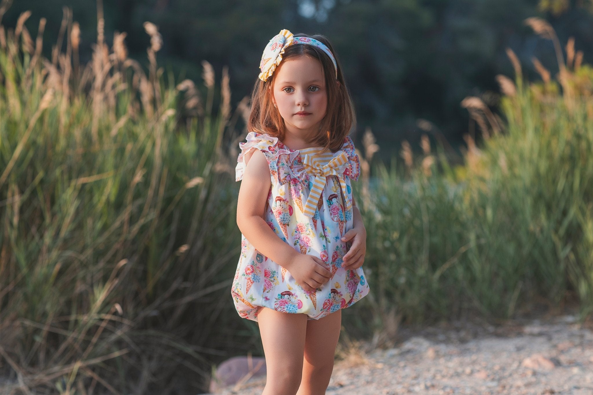 Young girl wearing rochy SS26 sweet collection Romper suit for Summer.