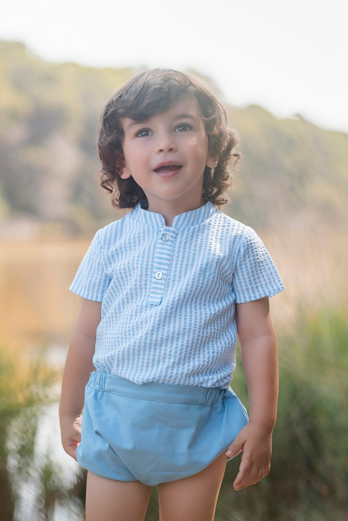 Little boy wearing Rochy SS26 Baby Blue Shorts & Shirt Set.