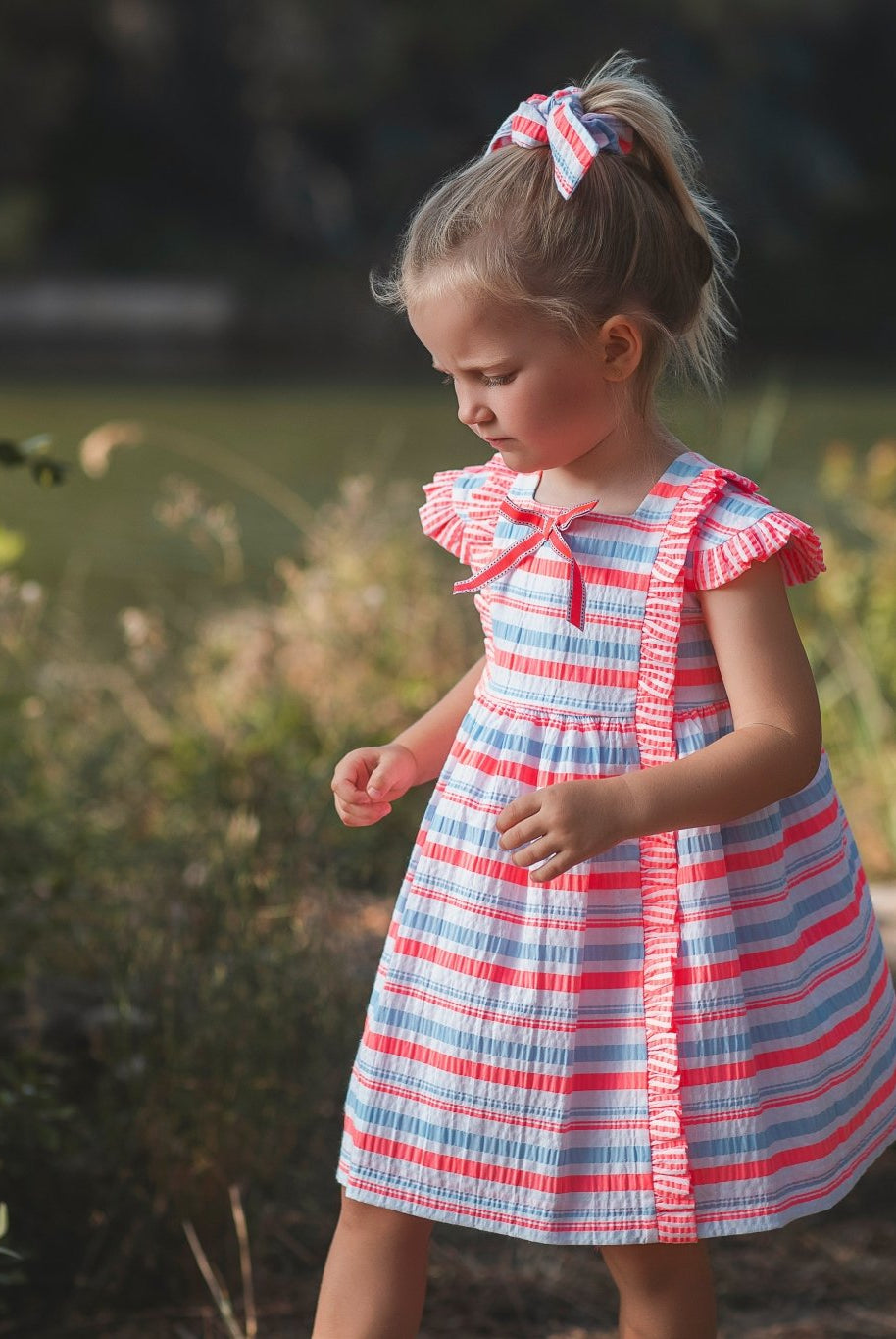 Little girl wearing Rochy SS26 Fluor Multi Coloured Neon Summer Dress
