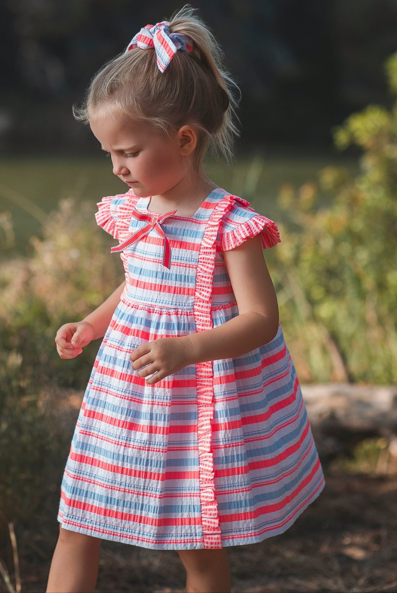 Little girl wearing Rochy SS26 Fluor Multi Coloured Neon Summer Dress