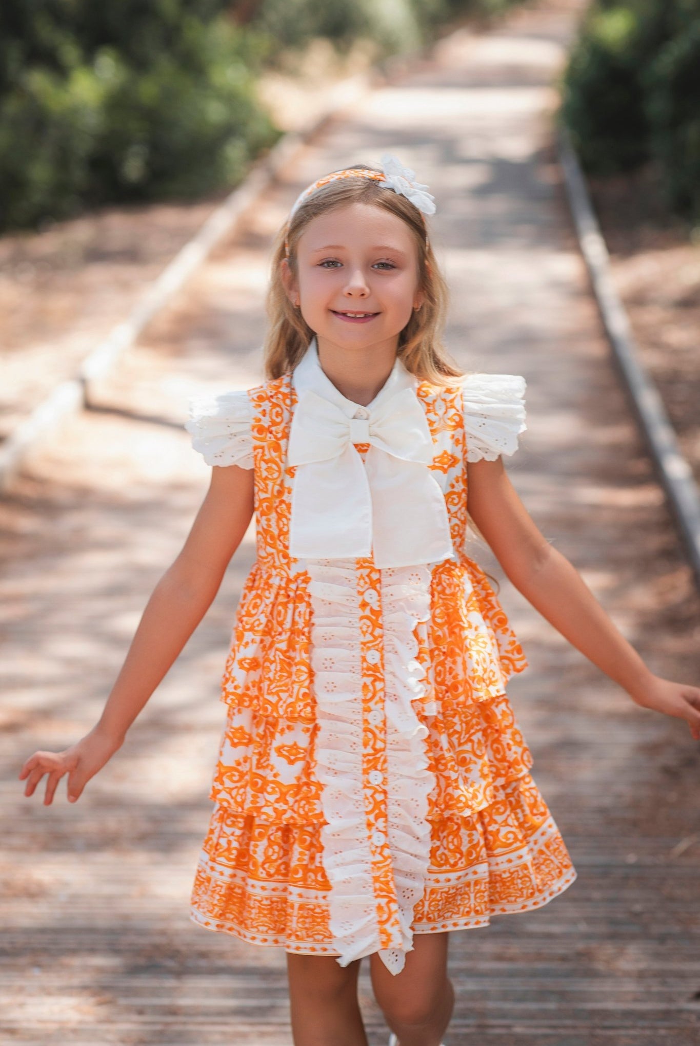 Girl wearing Rochy SS26 Orange and Cream D&G Inspired Print Summer Dress