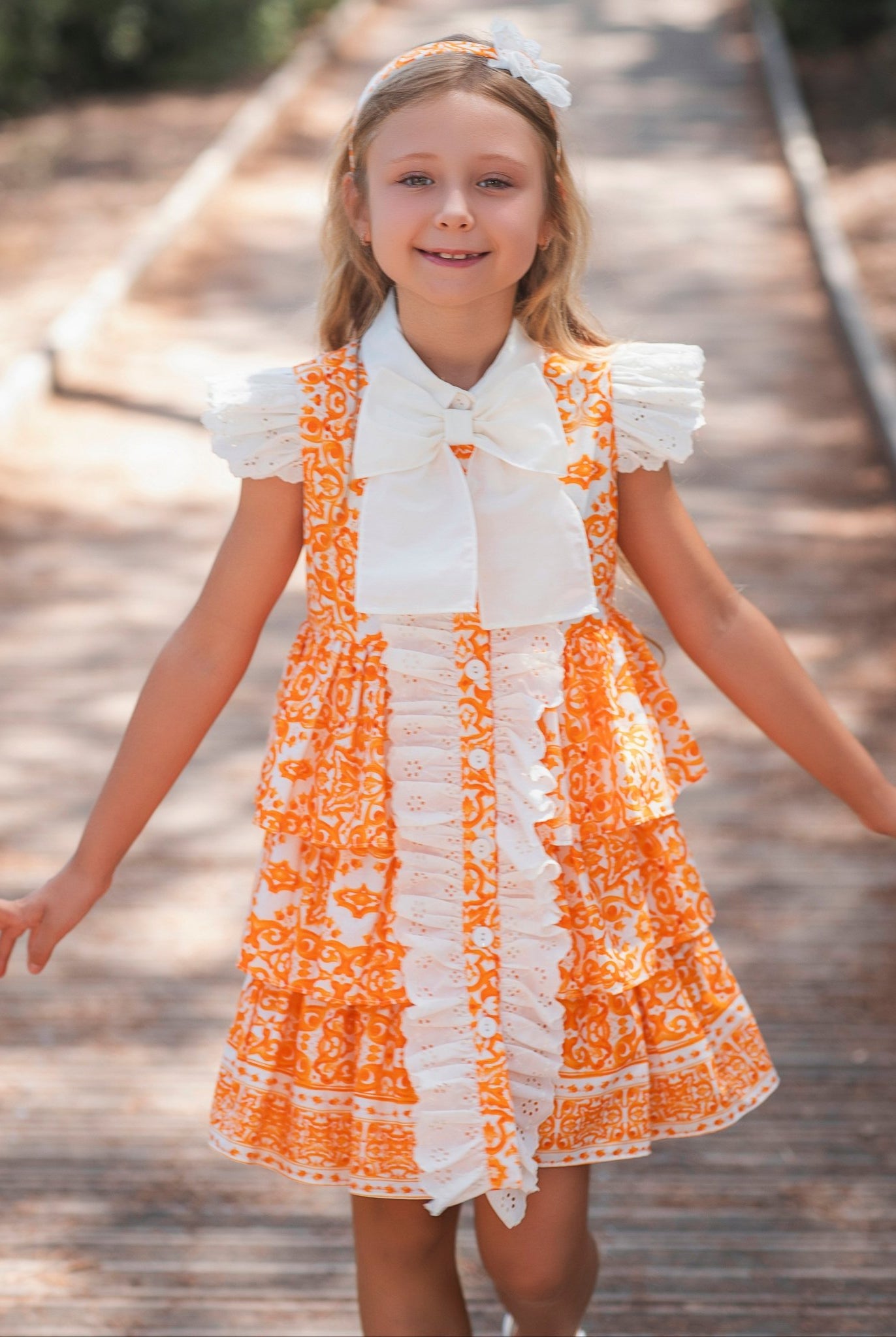 Girl wearing Rochy SS26 Orange and Cream D&G Inspired Print Summer Dress
