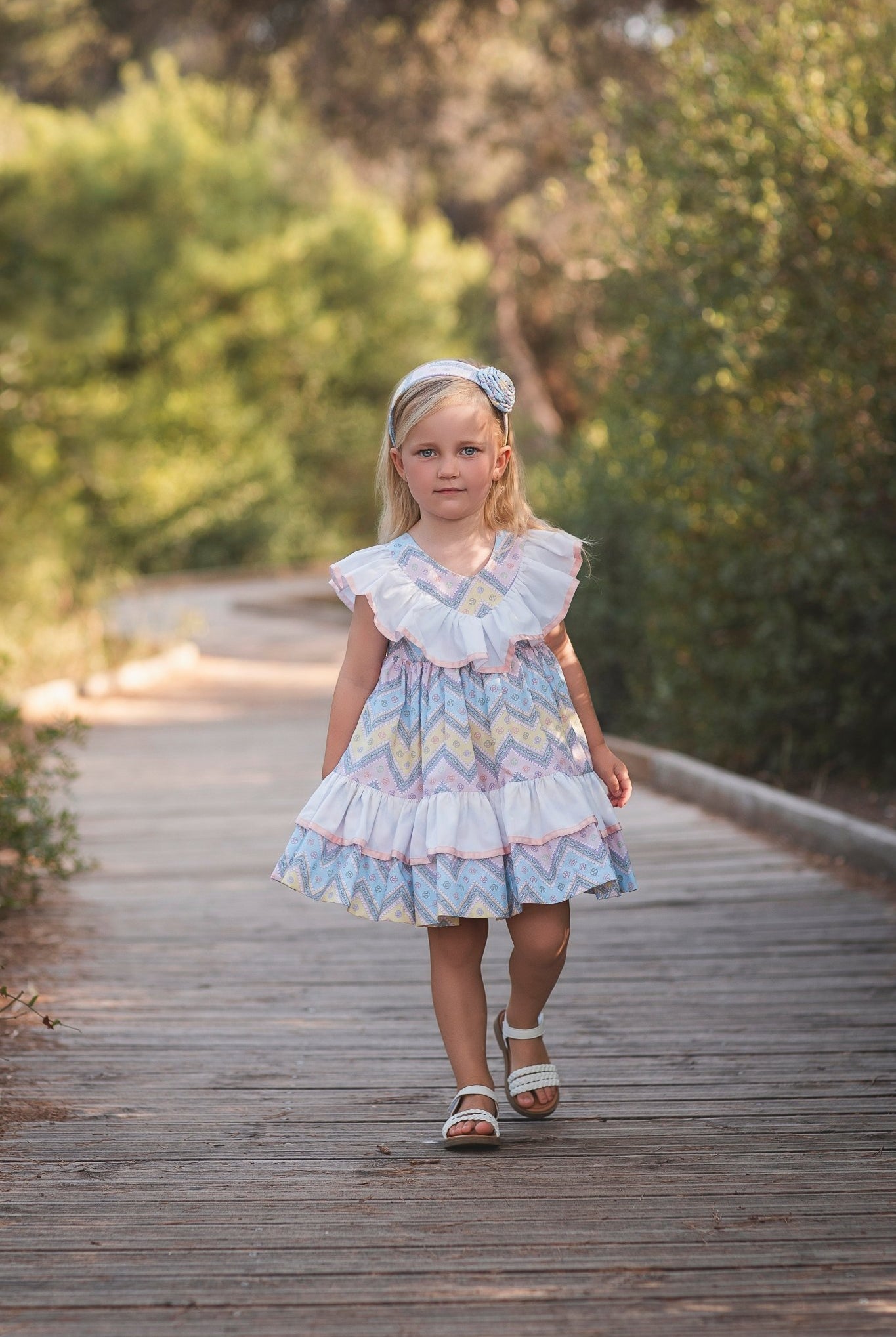 Girl wearing Rochy SS26 Multi Coloured pastel Zig Zag dress