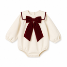 An off-white long-sleeve baby bodysuit featuring a large dark red velvet bow and matching trim on the collar, displayed against a solid white background.