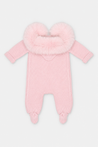 A light pink knit baby footed one-piece with a fluffy faux-fur hood trim, shown against a plain light gray background.