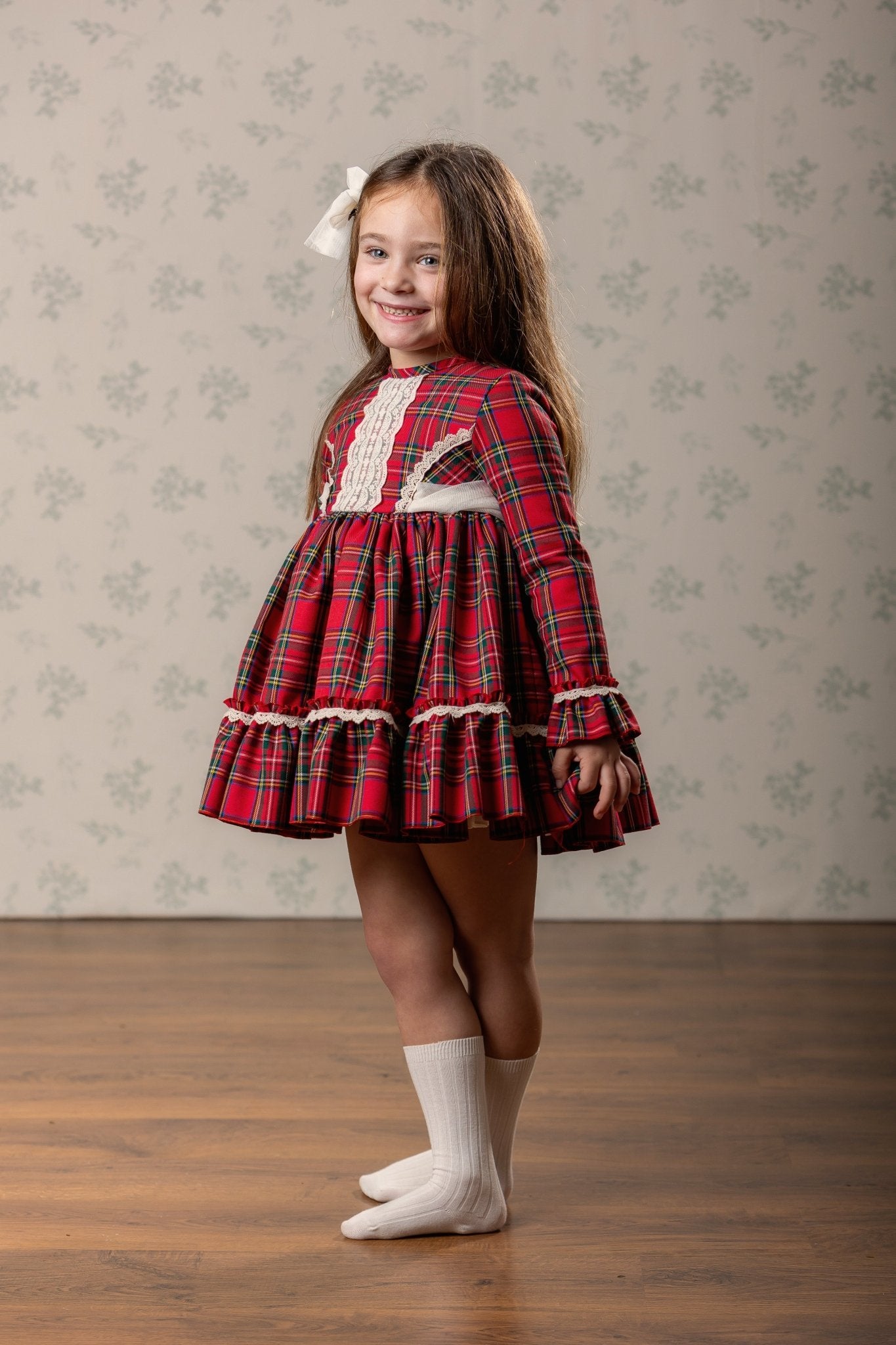 Abuela Tata girls red tartan Christmas dress with ivory lace and matching tartan headpiece AW26. 