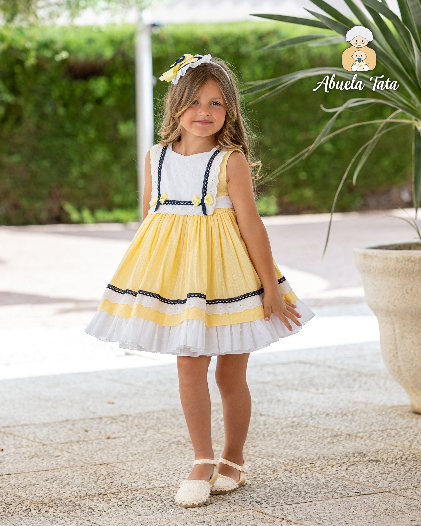 Abuela Tata girls yellow navy dress with matching headpiece SS26