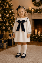 Be Chic girls ivory dress with navy velvet bow luxury Portuguese occasion dress AW26