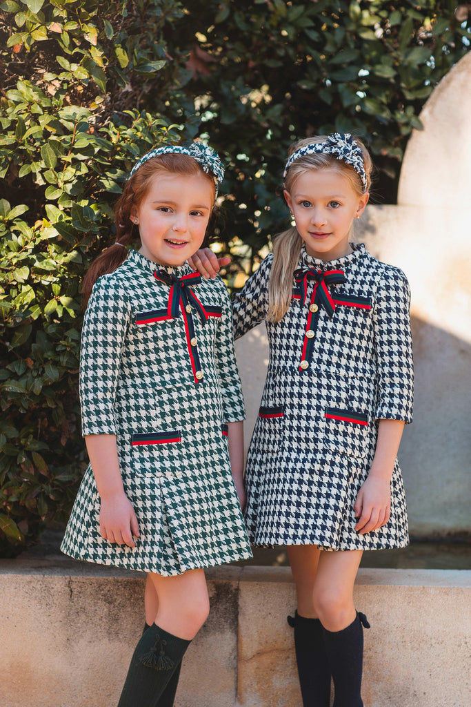 Meraki Bambini AW23 - Girls Navy Houndstooth Dress with Red, Navy & Green Detail Bow & Matching Headpiece - Mariposa Children's Boutique