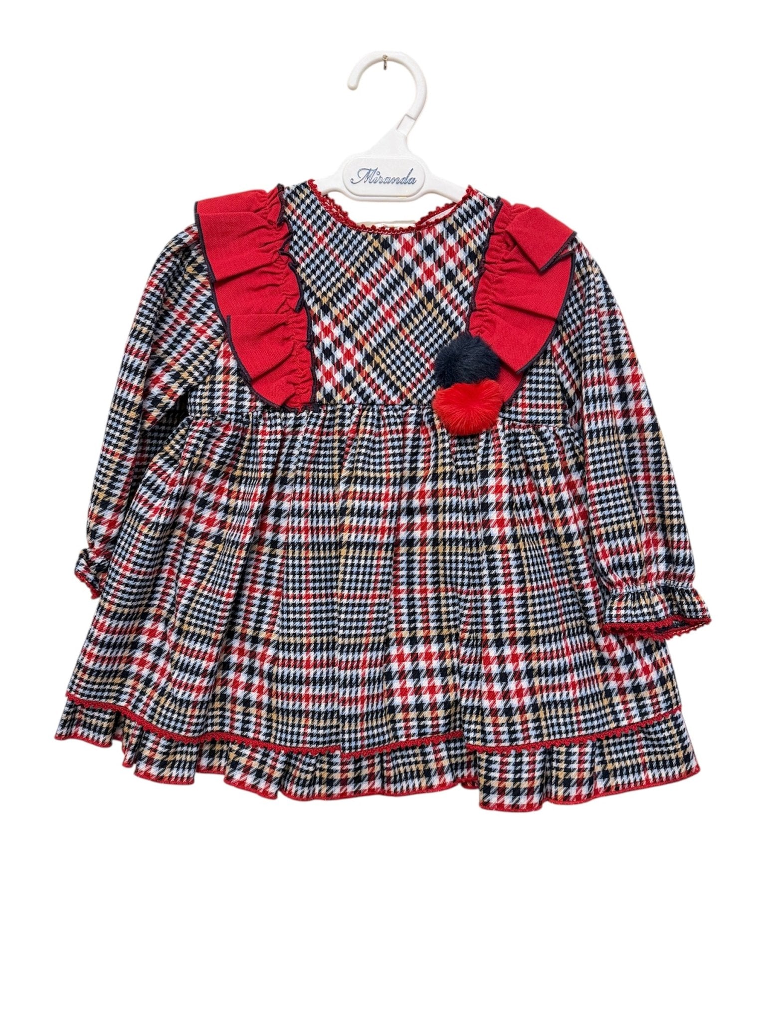 Plaid baby dress with red accents on a white background