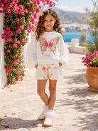 Daga SS26 Girls Twinkle Flight Cream sweater with butterfly motif and matching shorts. 
