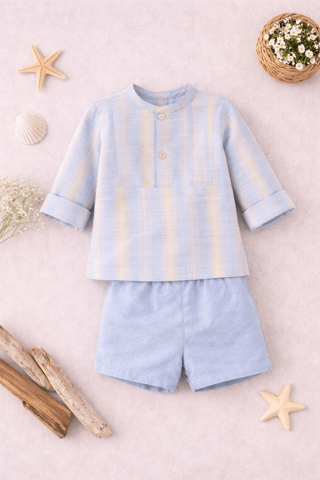 Children's light blue outfit with shirt and shorts on a neutral background