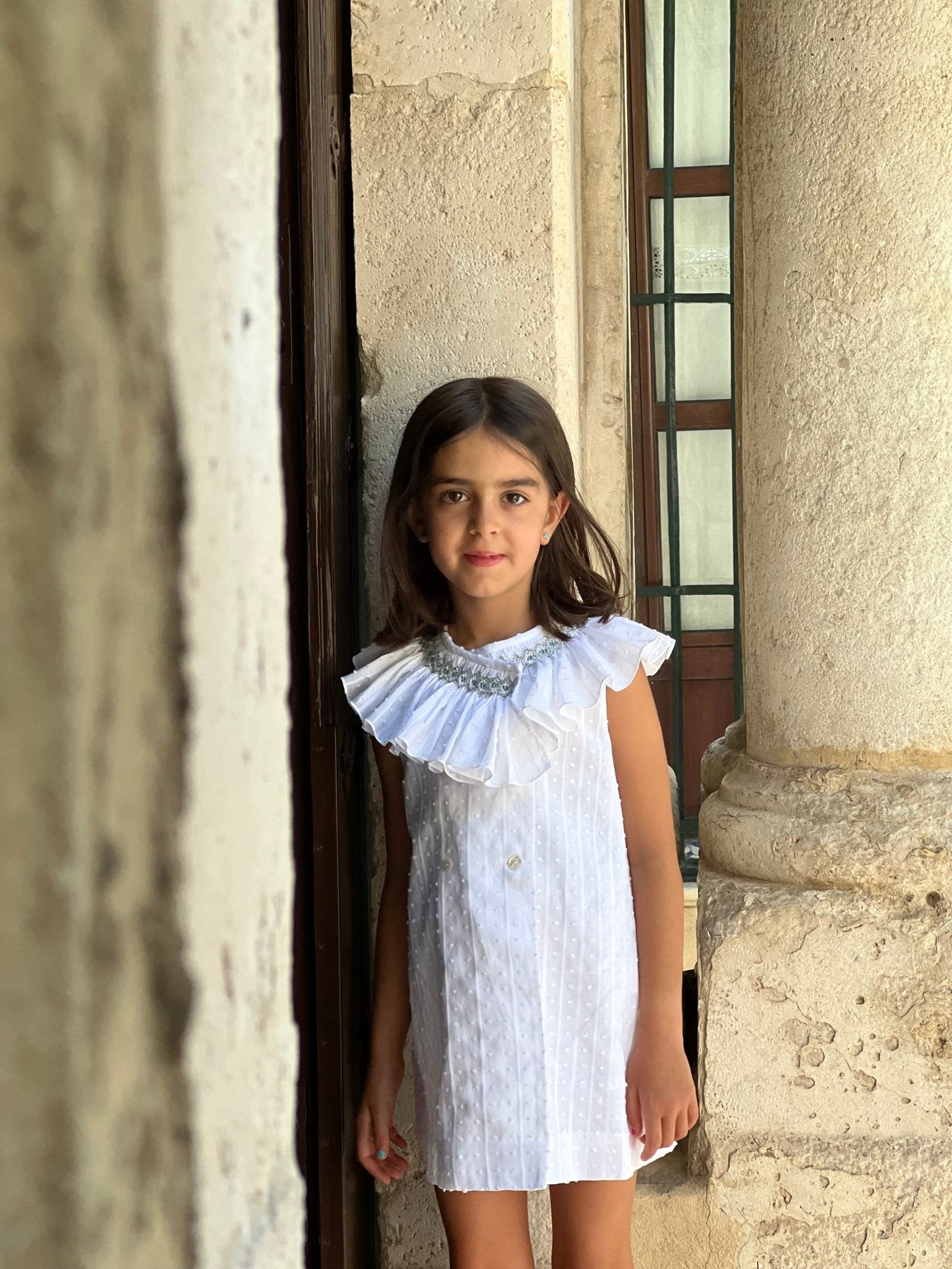 El Copo SS26 Girls White Dress with Ruffle Smocked Collar Detail. 