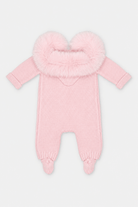 A light pink knit baby footed one-piece with a fluffy faux-fur hood trim, shown against a plain light gray background.