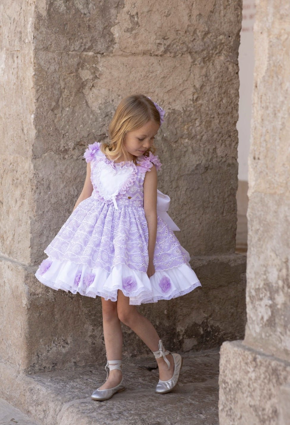 Meriche Alta Costura SS26 girls lilac heart dress with matching headpiece and layered puffball skirt.