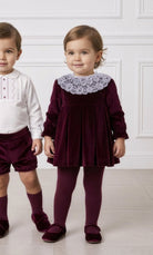 Baby girl burgundy velvet dress with lace collar detail.
