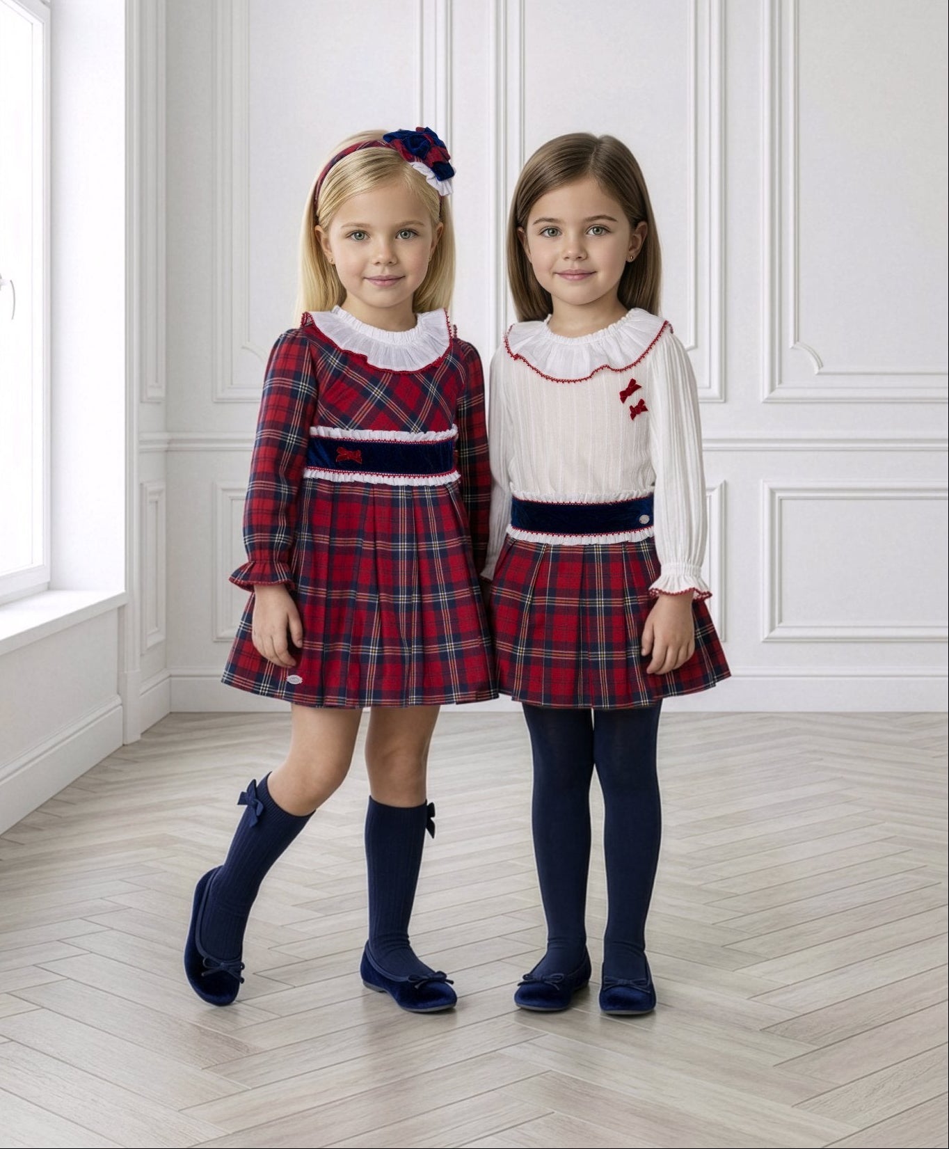 Two young girls wearing Miranda AW26 tartan collection dress and skirt and blouse set.  