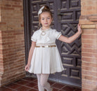 Naxos AW25 girls cream Chanel A-line dress with gold sequin waistband and pearl bow neckline