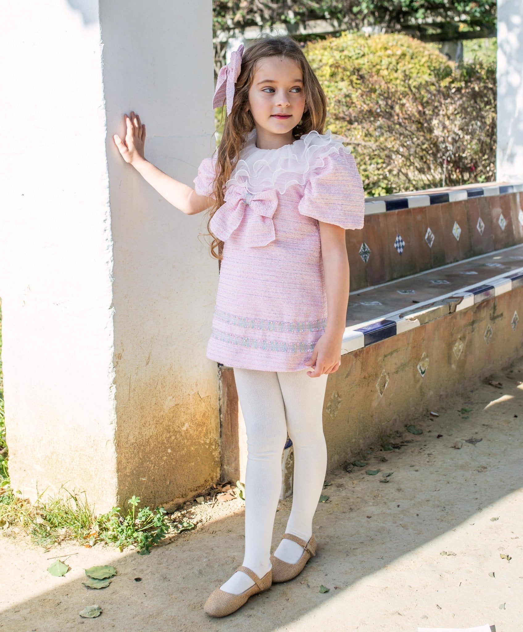 Girls pink tweed Spanish occasion dress by Naxos with bow detail
