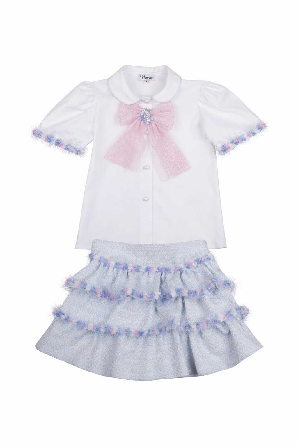 Girl wearing Naxos SS26 blue tweed ruffle skirt and white blouse with pink bow