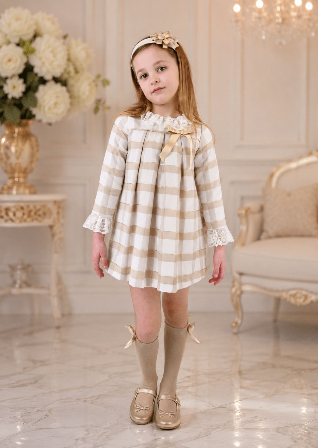 Girls Rochy Cream, Gold and Camel Dress on a child model standing in a luxury room. 