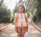 Little girl wearing Rochy SS26 Orange D&G Print Bloomer shorts Set. 