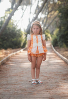 Little girl wearing Rochy SS26 Orange D&G Print Bloomer shorts Set. 