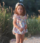 Young girl wearing rochy SS26 sweet collection Romper suit for Summer. 