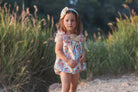 Young girl wearing rochy SS26 sweet collection Romper suit for Summer. 
