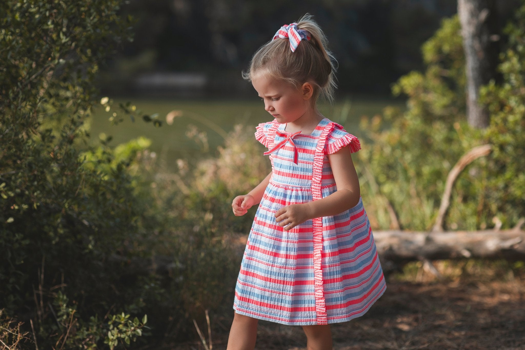 Little girl wearing Rochy SS26 Fluor Multi Coloured Neon Summer Dress 