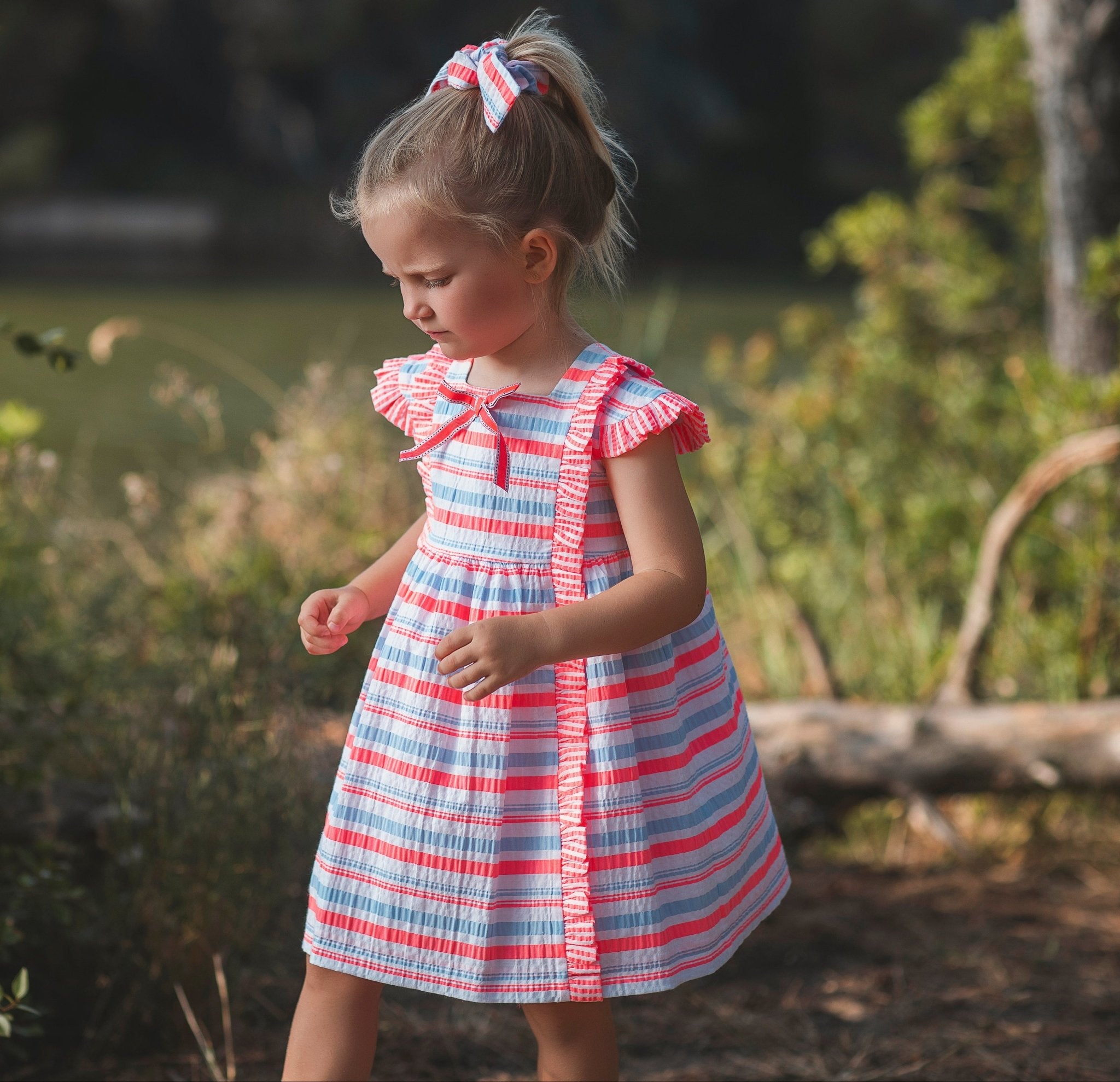 Little girl wearing Rochy SS26 Fluor Multi Coloured Neon Summer Dress 