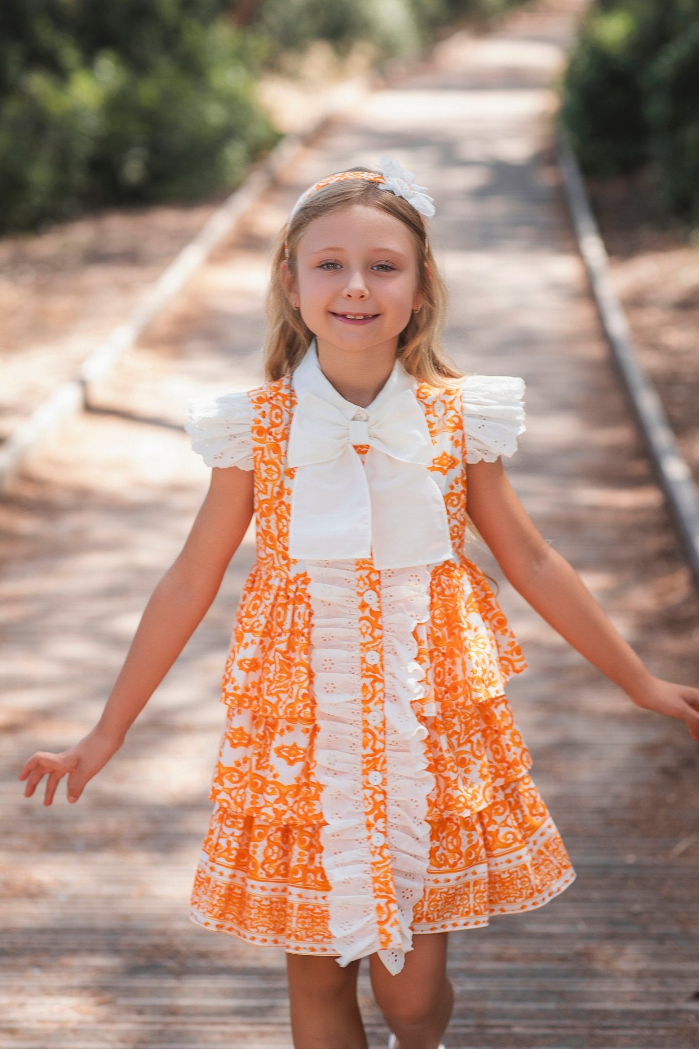 Girl wearing Rochy SS26 Orange and Cream D&G Inspired Print Summer Dress