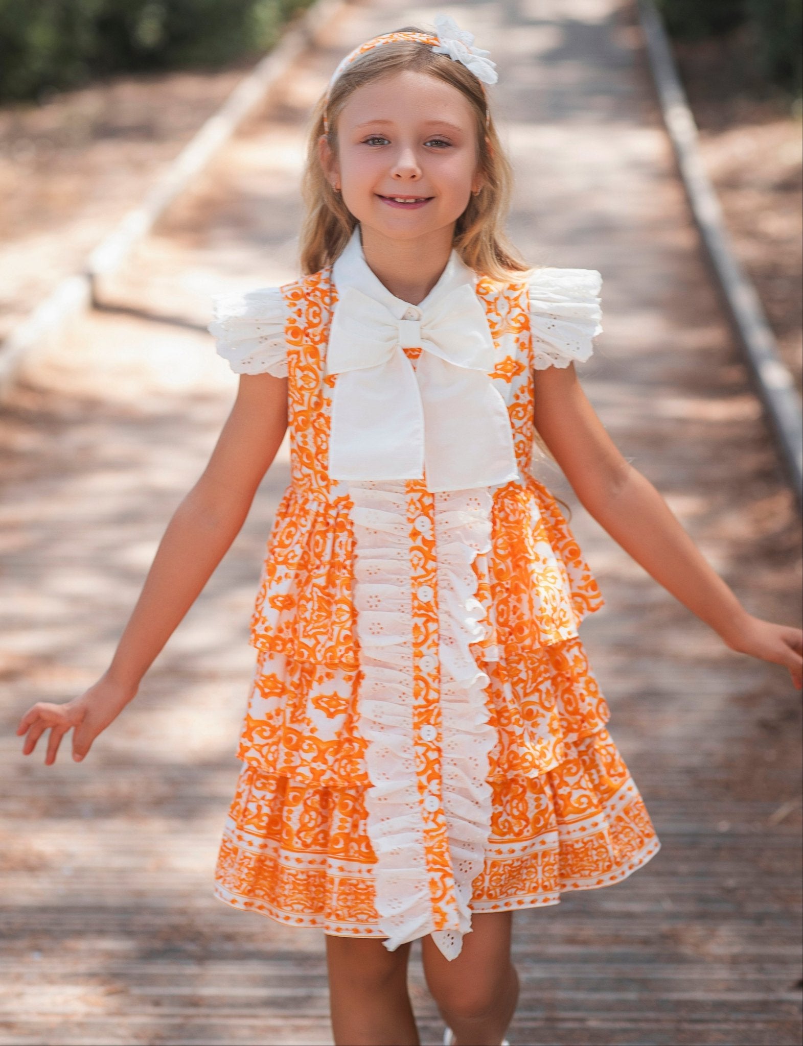 Girl wearing Rochy SS26 Orange and Cream D&G Inspired Print Summer Dress