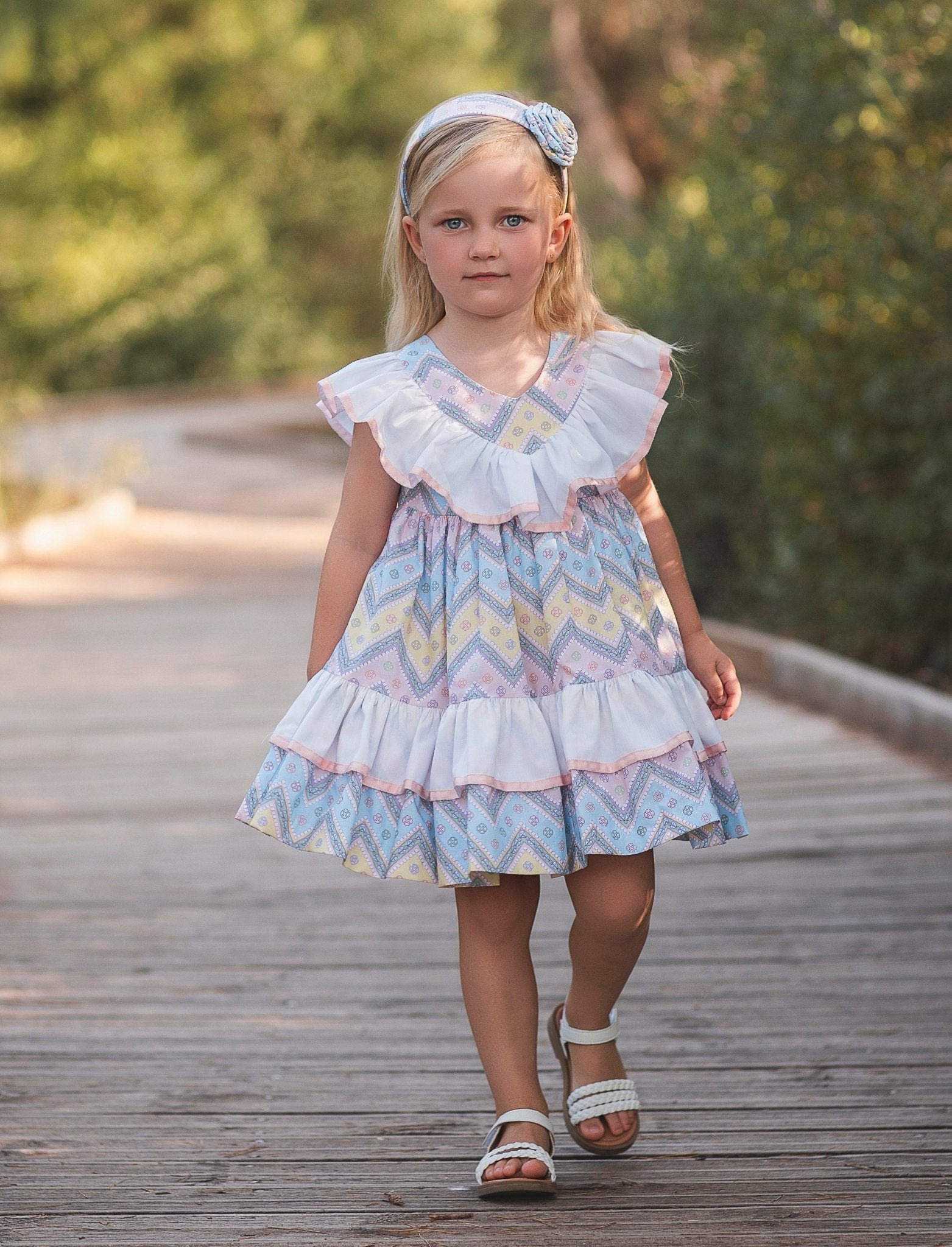 Girl wearing Rochy SS26 Multi Coloured pastel Zig Zag dress