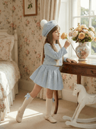 Girls luxury blue Chanel-inspired skirt and jacket set by Sonata with matching hat, SS26 made-to-order occasion wear.