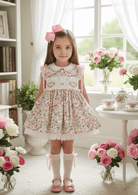 Shop the Sonata girls heart smocked floral dress from the SS26 collection. Traditional puffball style perfect for Easter and occasions.