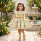 Yellow floral smocked dress with matching bow by Sonata for SS26